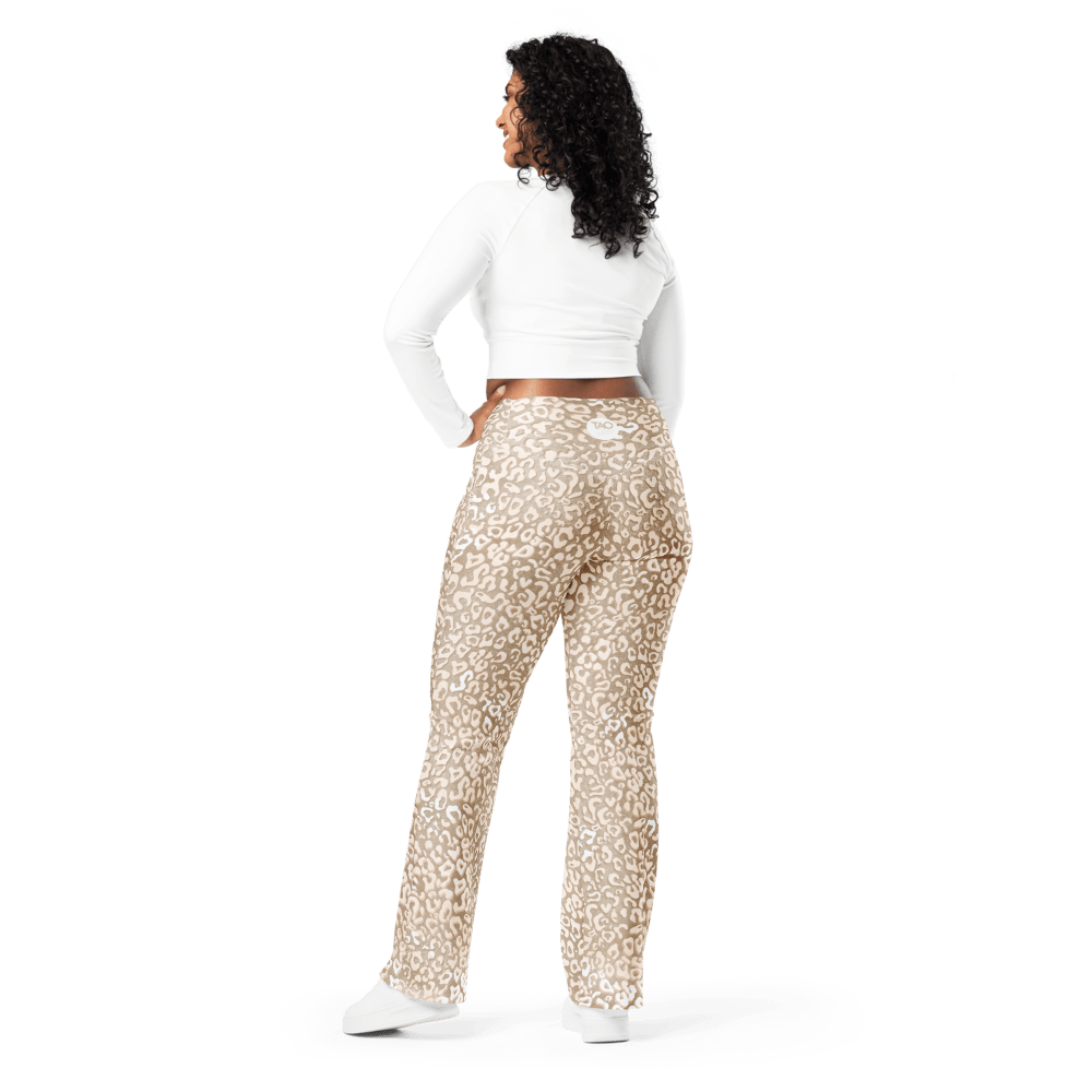 Woman wearing high-waisted leopard print flare leggings with a butt-lifting cut and double waistband, made from recycled fabric with UPF 50+ protection — bold, sculpting, and sustainably made for confident movement.