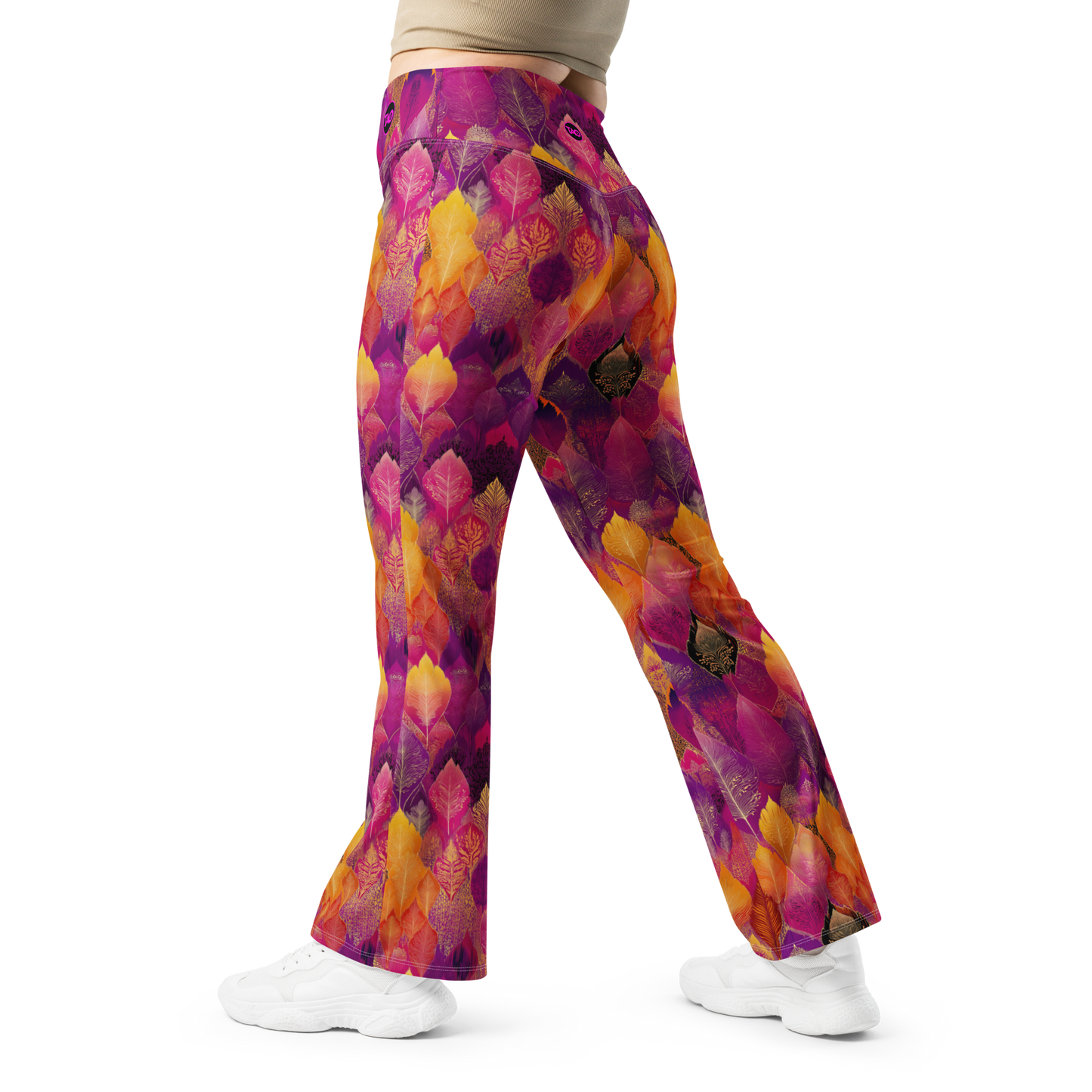 Woman wearing high-waisted flared leggings with a bold spice-toned print, featuring a supportive fit and sustainable fabric, inspired by Southeast Asian design.