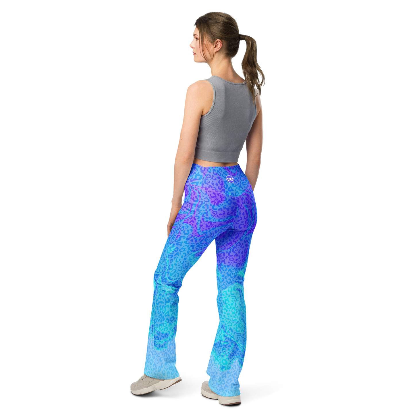 Model wearing Blue Aurora Leopardy flared leggings with high waist and vibrant leopard print – TAO Infinity