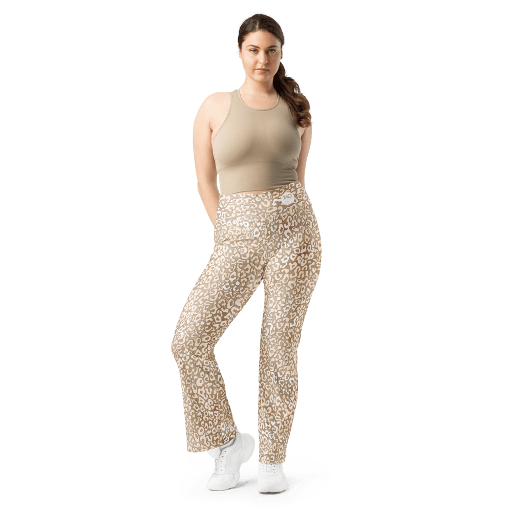 Woman wearing high-waisted leopard print flare leggings with a butt-lifting cut and double waistband, made from recycled fabric with UPF 50+ protection — bold, sculpting, and sustainably made for confident movement.
