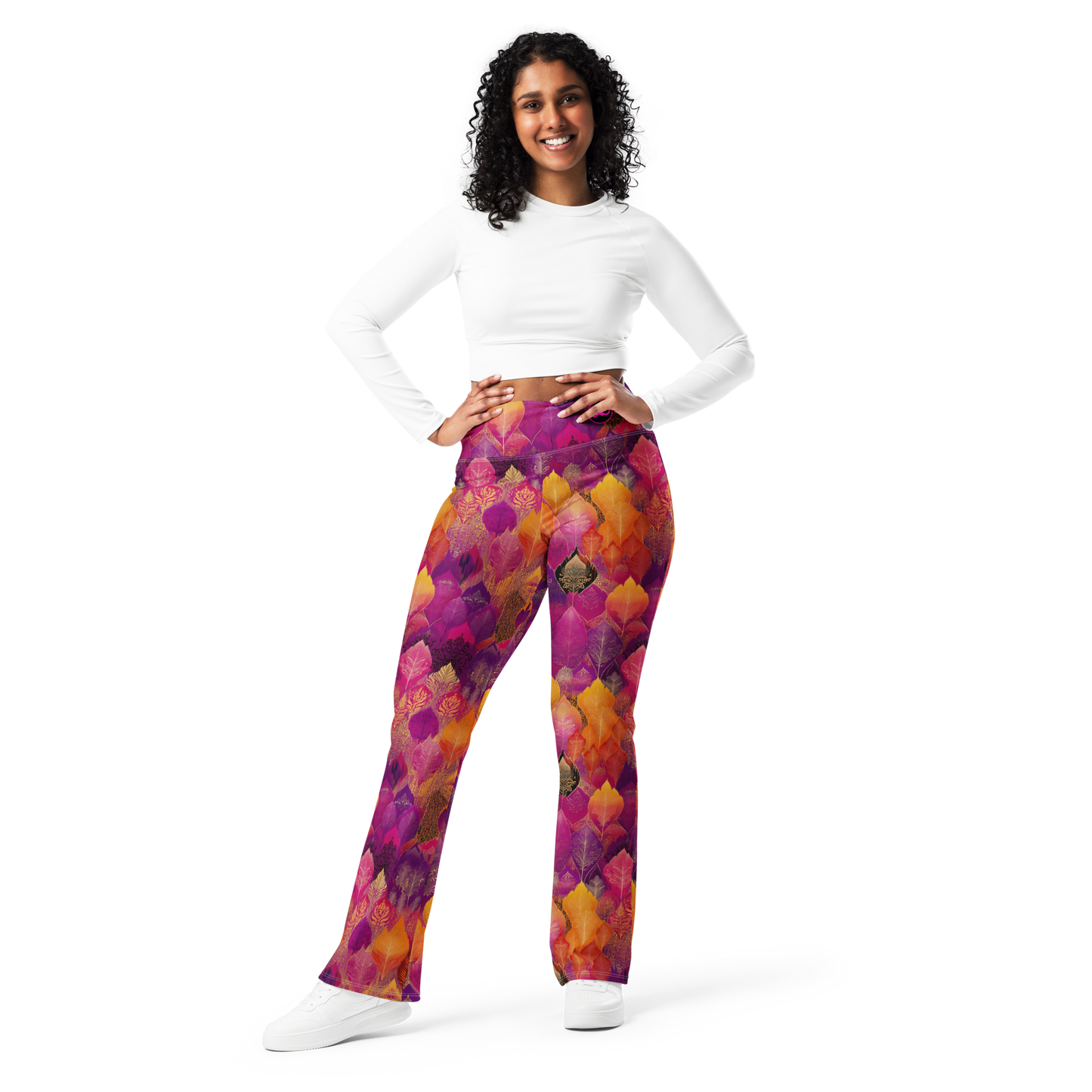 Woman wearing high-waisted flared leggings with a bold spice-toned print, featuring a supportive fit and sustainable fabric, inspired by Southeast Asian design.