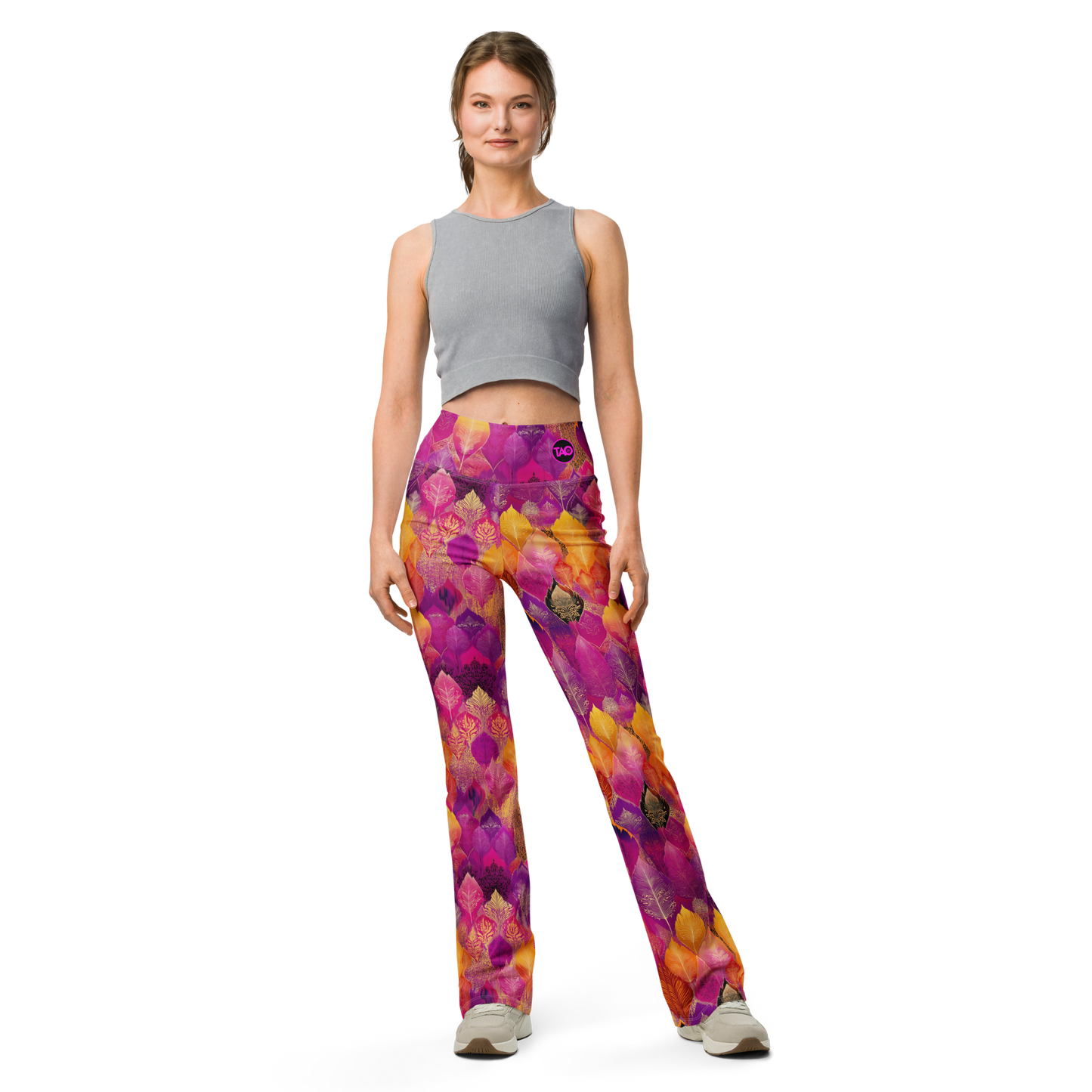 Woman wearing high-waisted flared leggings with a bold spice-toned print, featuring a supportive fit and sustainable fabric, inspired by Southeast Asian design.