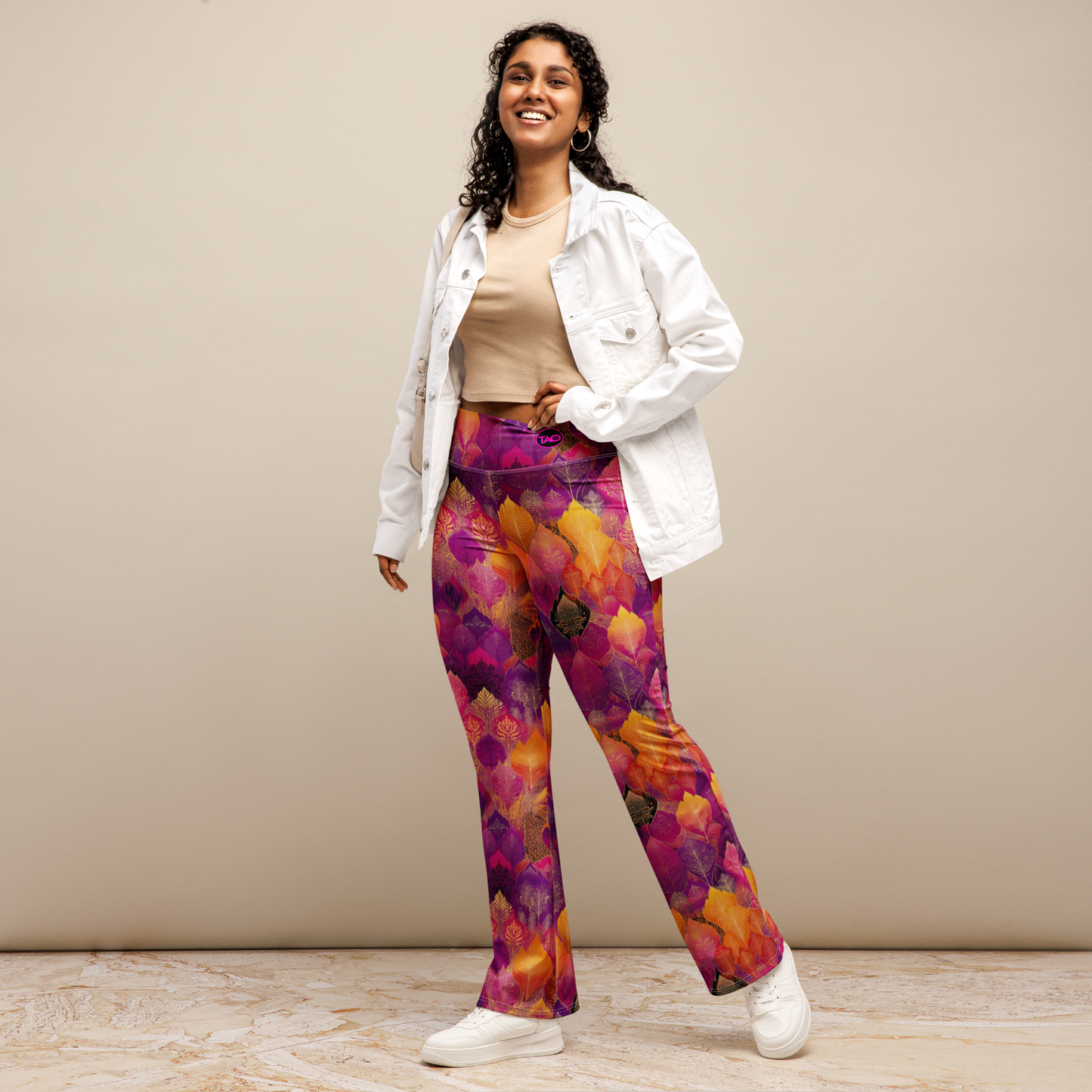Woman wearing high-waisted flared leggings with a bold spice-toned print, featuring a supportive fit and sustainable fabric, inspired by Southeast Asian design.