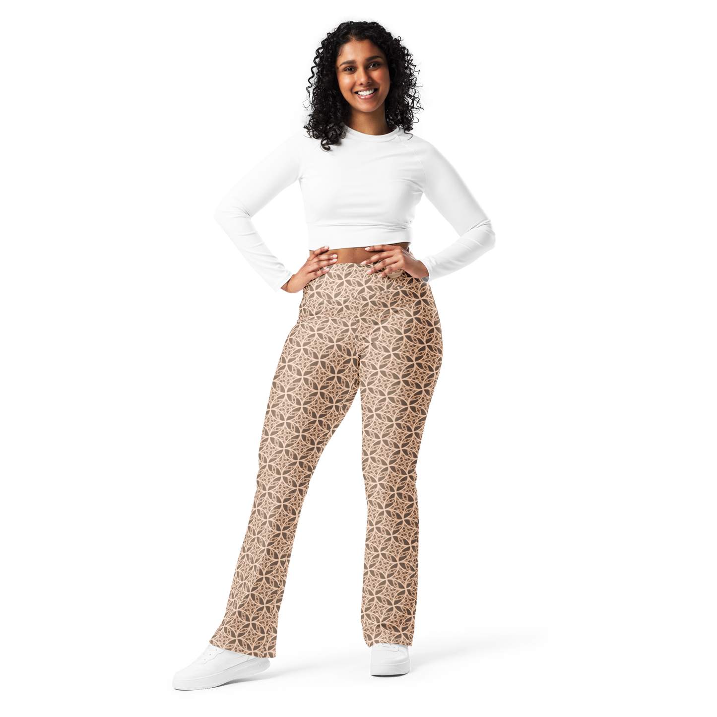 Woman wearing high-waisted beige flare leggings inspired by the Fibonacci sequence, featuring a butt-lifting cut, soft compression fabric, and a sustainable fit designed for movement, elegance, and spiritual flow.