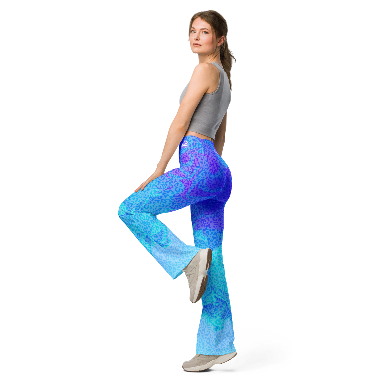 Model wearing Blue Aurora Leopardy flared leggings with high waist and vibrant leopard print – TAO Infinity