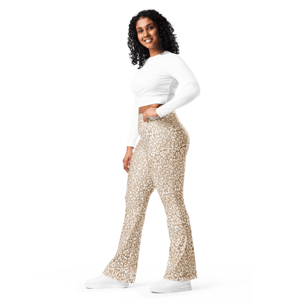 Woman wearing high-waisted leopard print flare leggings with a butt-lifting cut and double waistband, made from recycled fabric with UPF 50+ protection — bold, sculpting, and sustainably made for confident movement.