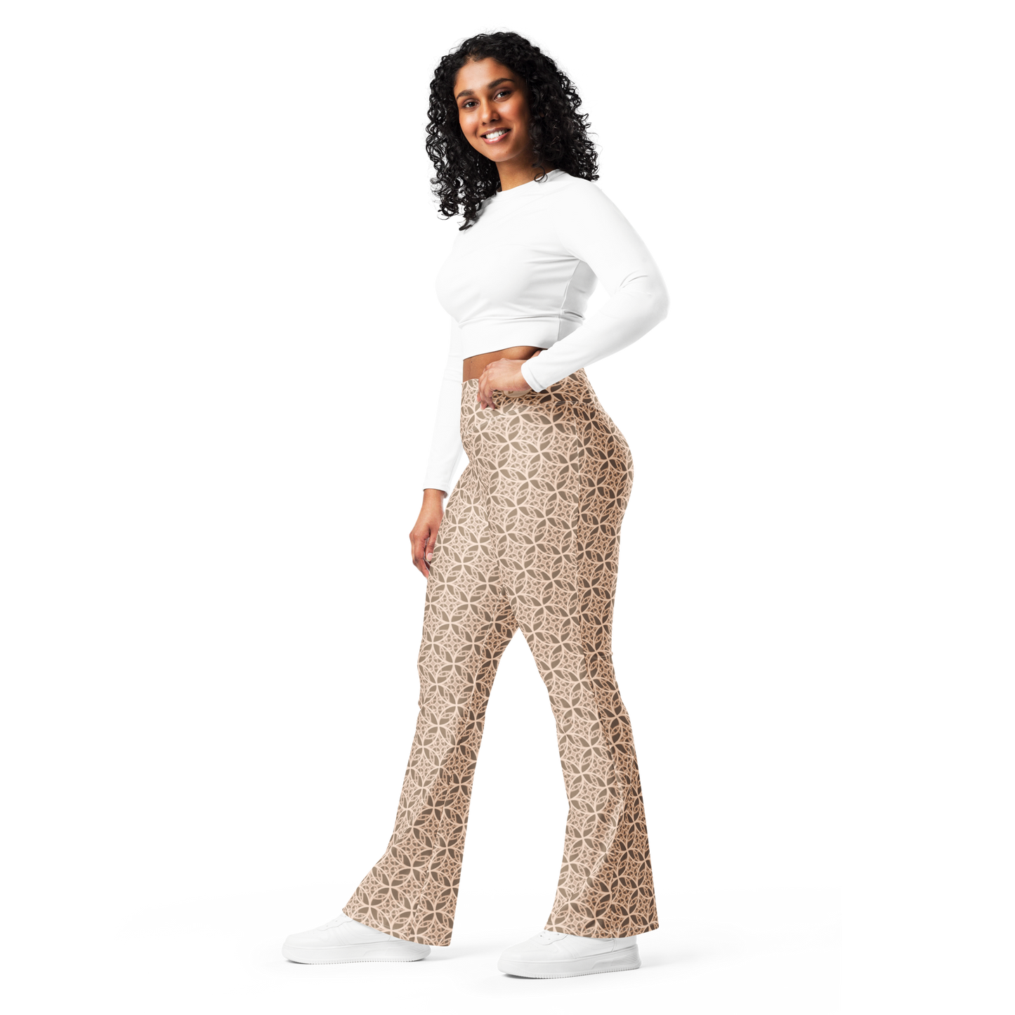 Woman wearing high-waisted beige flare leggings inspired by the Fibonacci sequence, featuring a butt-lifting cut, soft compression fabric, and a sustainable fit designed for movement, elegance, and spiritual flow.