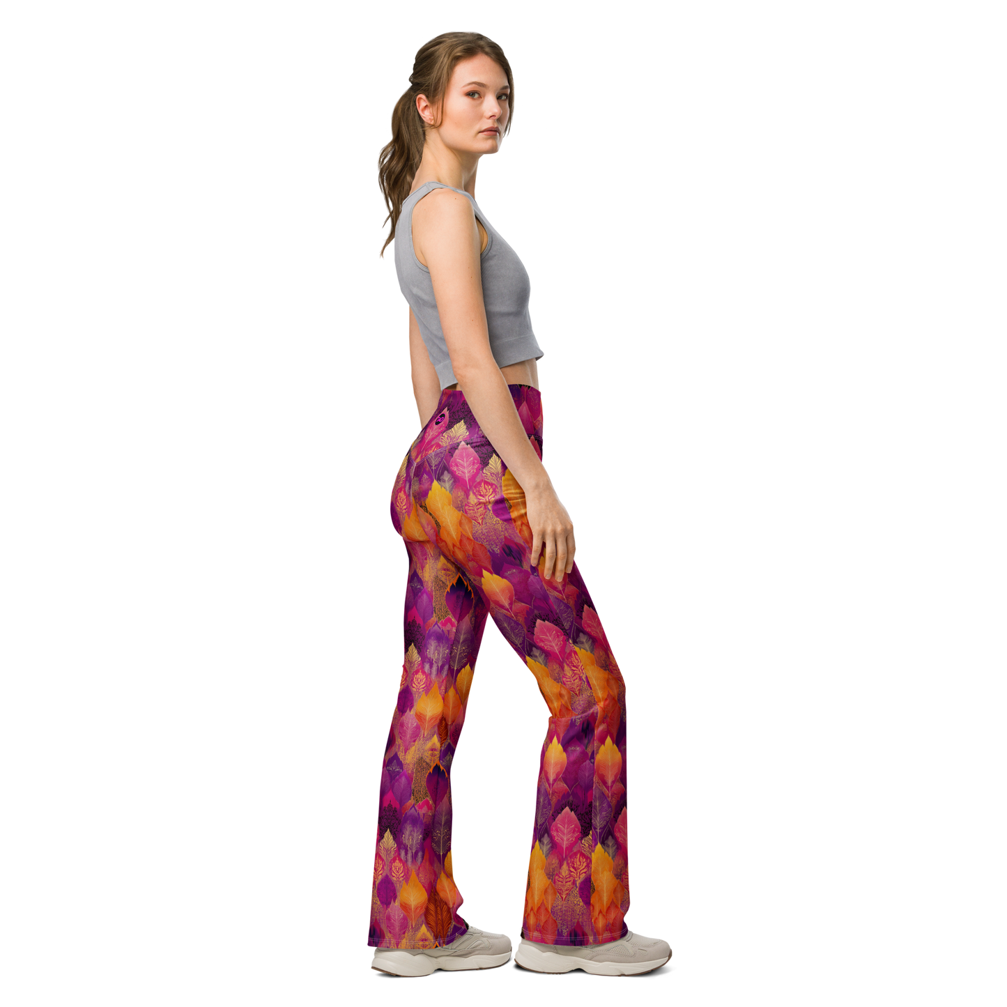 Woman wearing high-waisted flared leggings with a bold spice-toned print, featuring a supportive fit and sustainable fabric, inspired by Southeast Asian design.