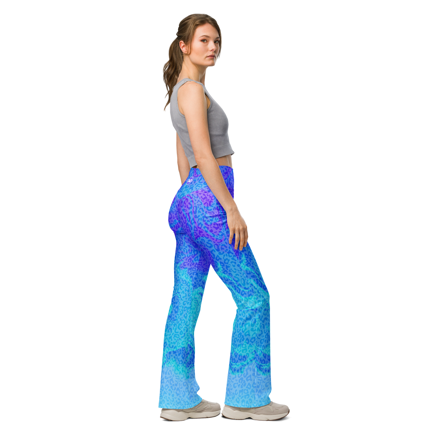 Model wearing Blue Aurora Leopardy flared leggings with high waist and vibrant leopard print – TAO Infinity
