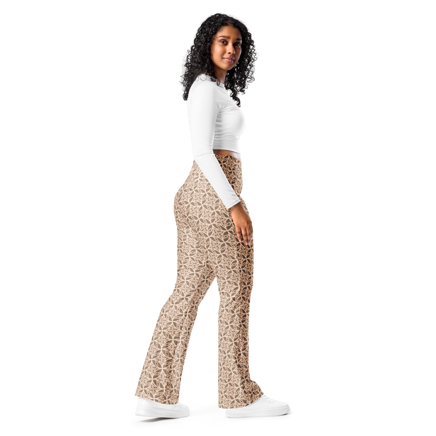 Woman wearing high-waisted beige flare leggings inspired by the Fibonacci sequence, featuring a butt-lifting cut, soft compression fabric, and a sustainable fit designed for movement, elegance, and spiritual flow.