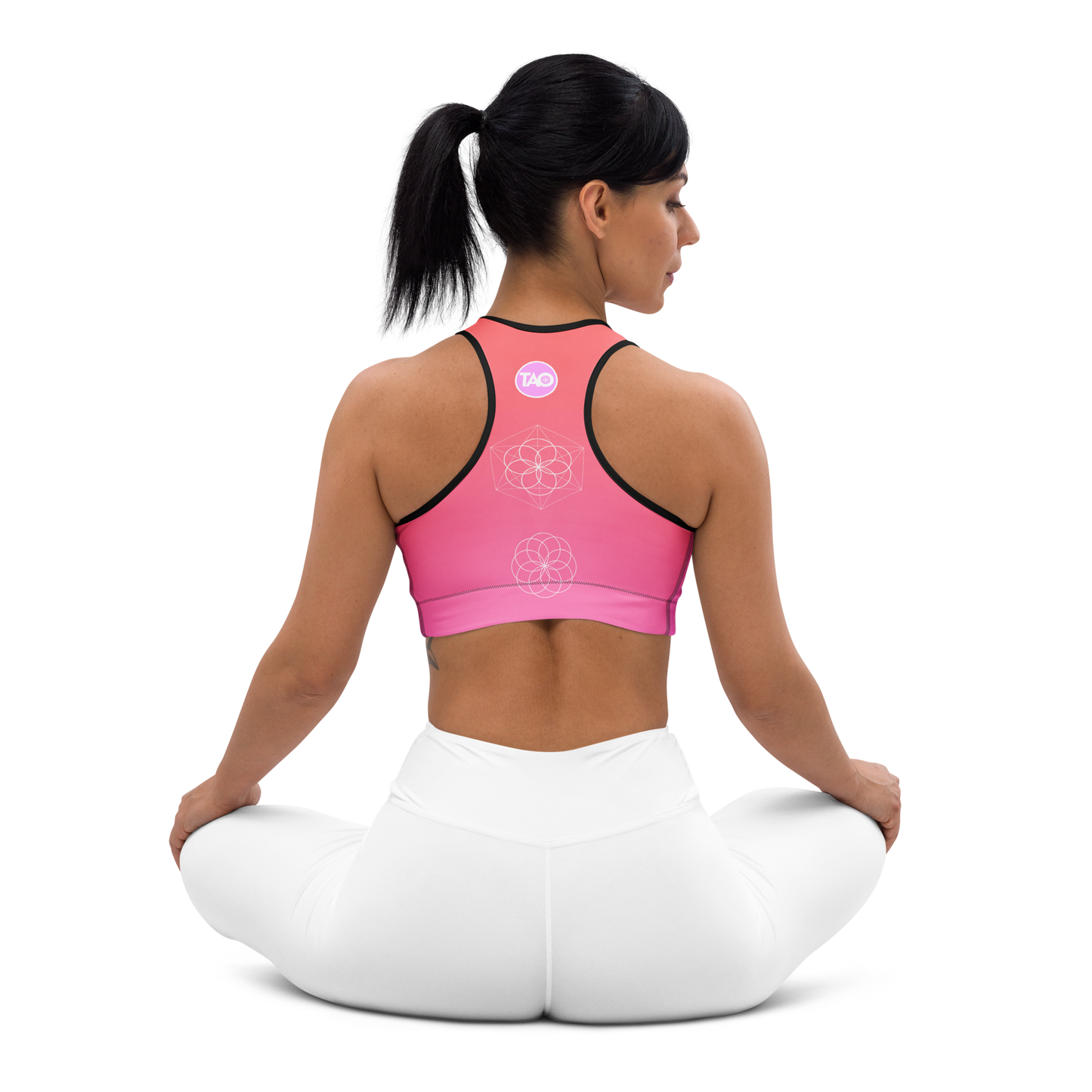 Woman wearing a blush-toned floral sports bra with scoop neckline, racerback, removable padding, and wide elastic underband — designed for medium support, comfort, and movement with a feminine flair.
