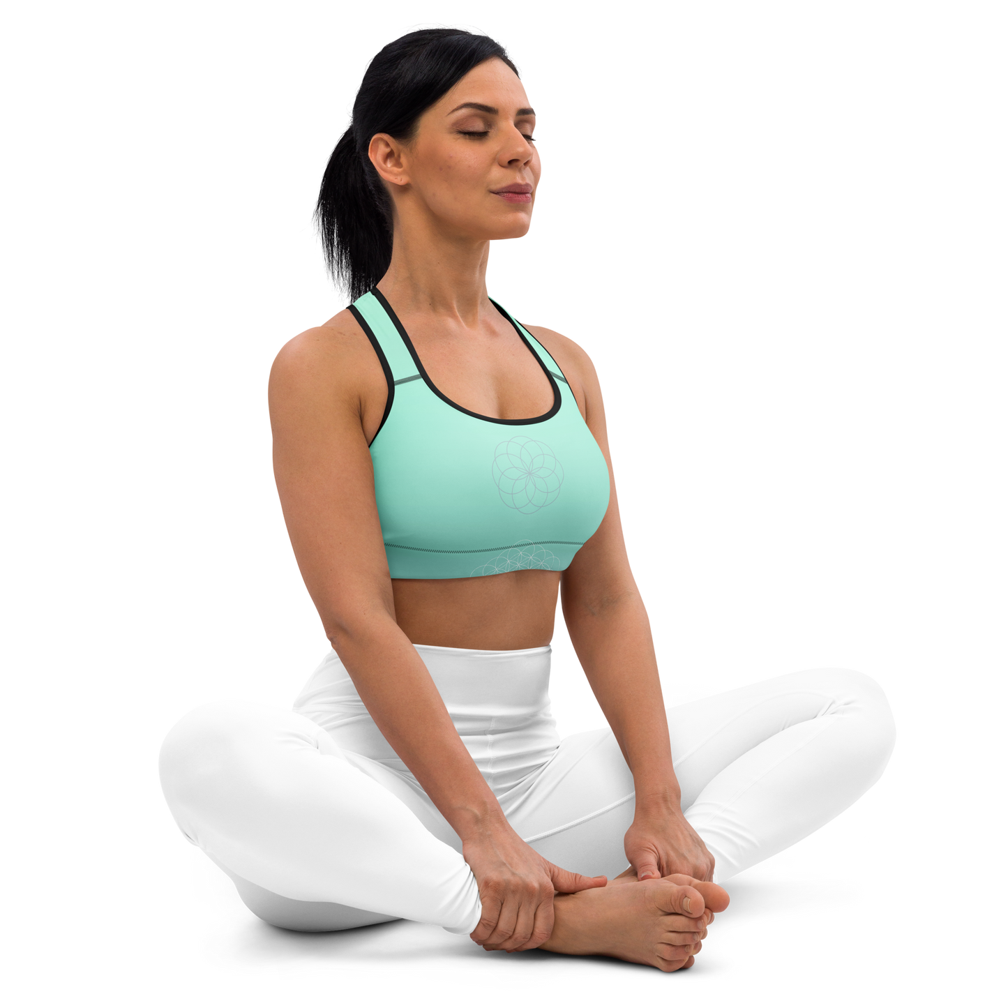 Woman wearing a mint green sports bra with sacred mandala print, scoop neckline, racerback design, and wide underband — made for flexible movement and calm, conscious strength.