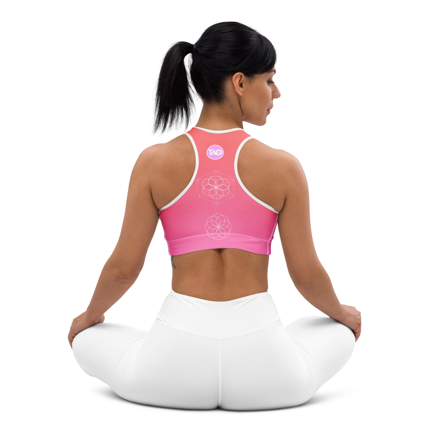 Woman wearing a blush-toned floral sports bra with scoop neckline, racerback, removable padding, and wide elastic underband — designed for medium support, comfort, and movement with a feminine flair.