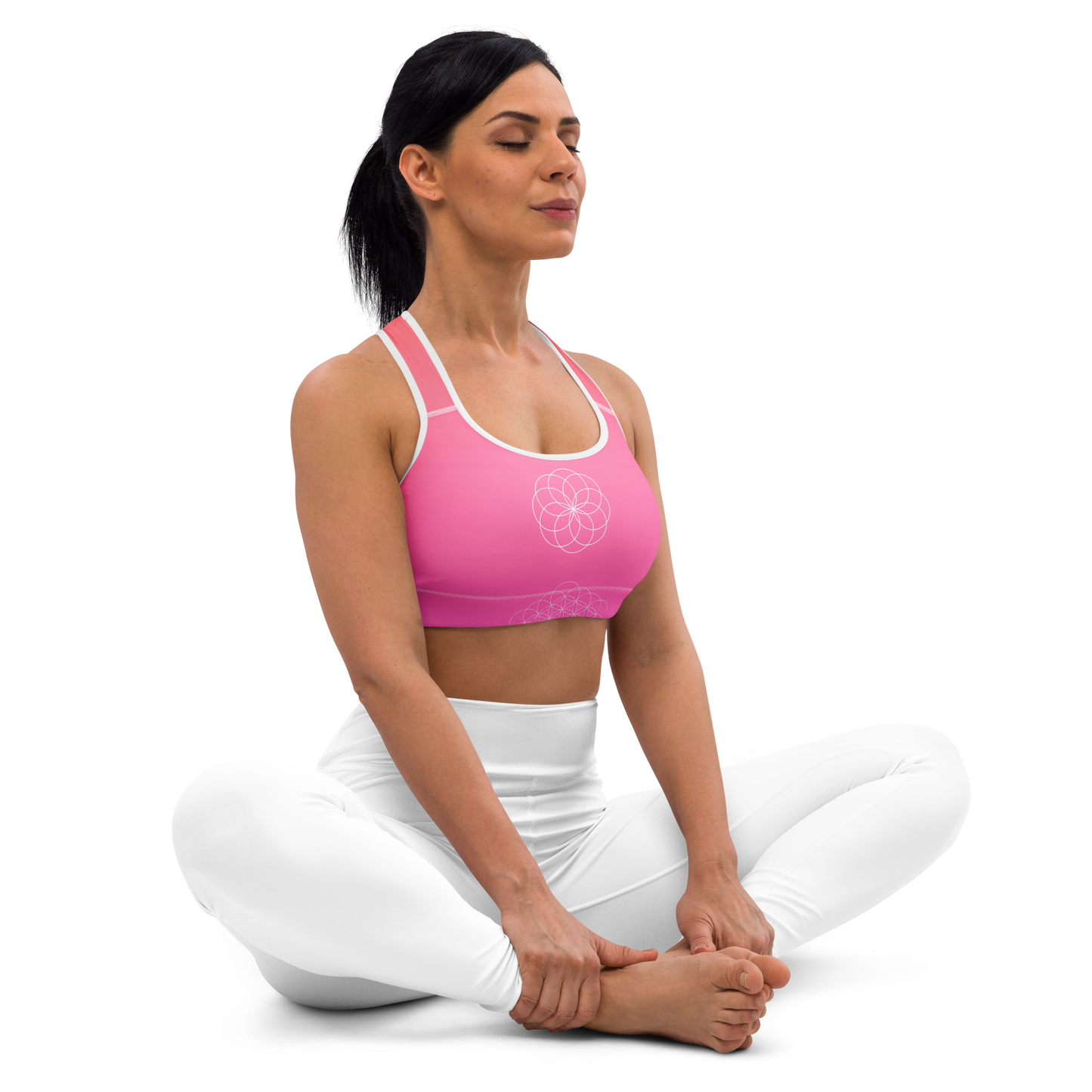 Woman wearing a blush-toned floral sports bra with scoop neckline, racerback, removable padding, and wide elastic underband — designed for medium support, comfort, and movement with a feminine flair.