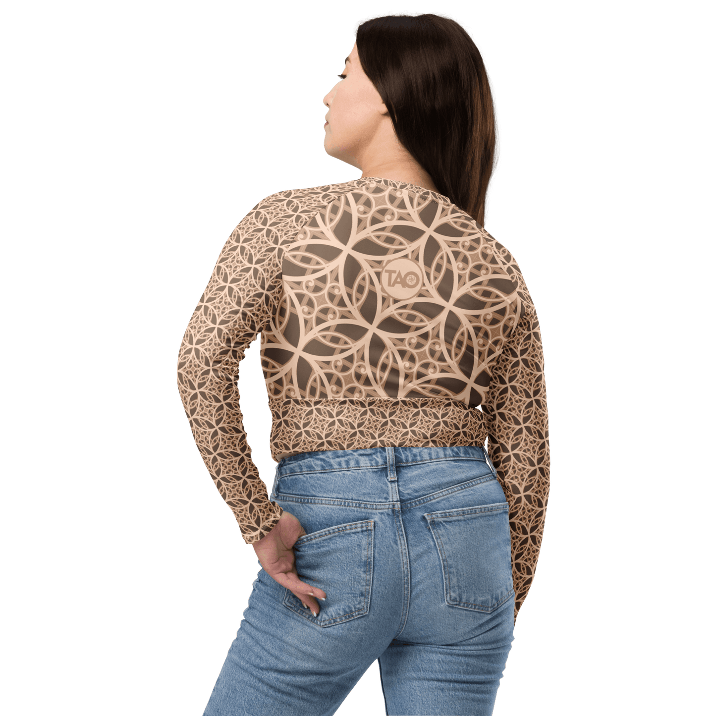 Woman wearing a beige long sleeve cropped top with raglan sleeves, a double-layered waistband, and sacred geometry-inspired design — made from recycled fabric with UPF 50+ protection for sustainable style and mindful movement.