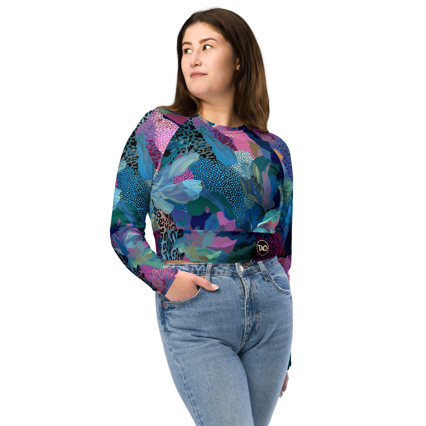 Woman wearing a blue camo-print long sleeve crop top with raglan sleeves, double-layered waistband, and UPF 50+ protection — made from recycled fabric for stylish, eco-conscious performance.