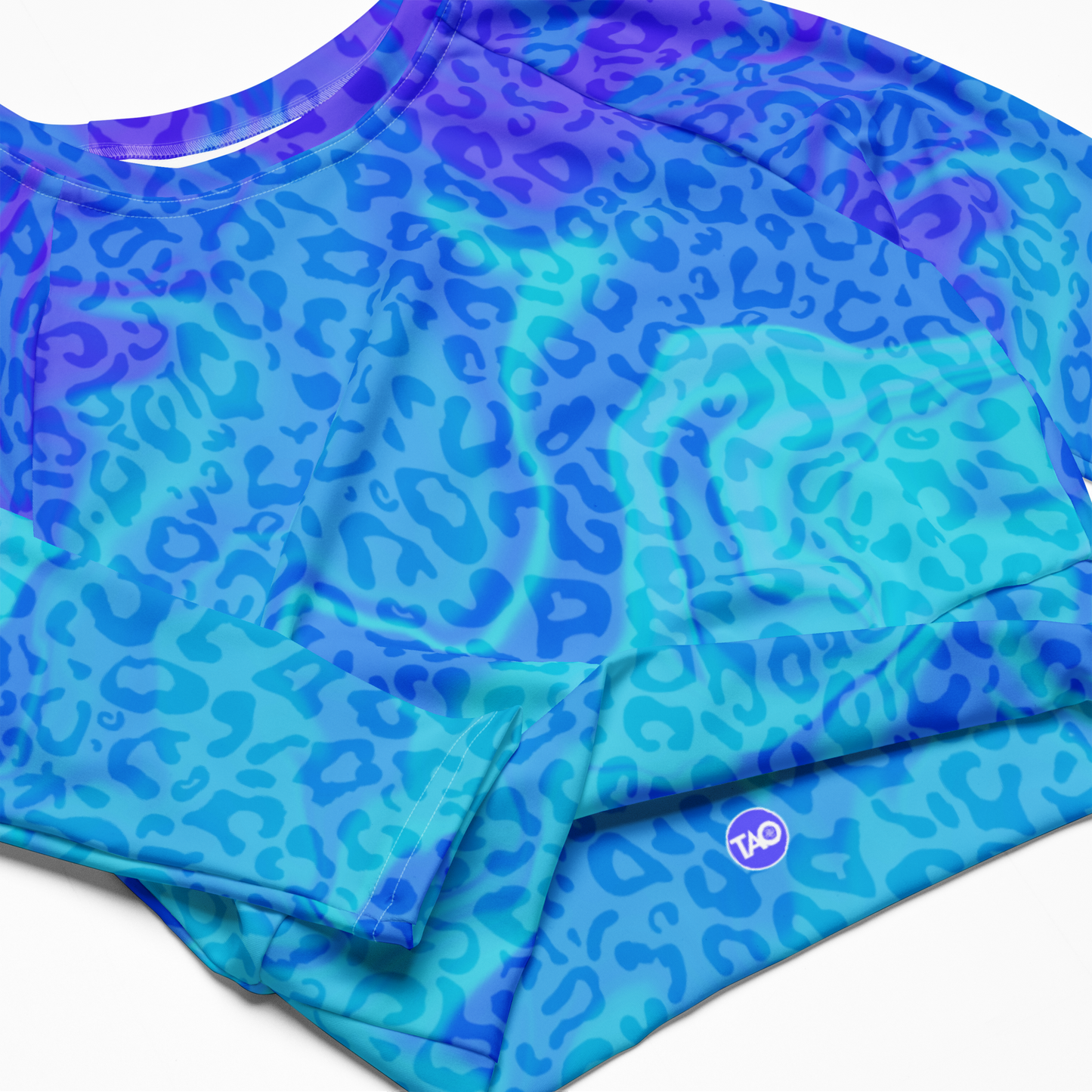 Model wearing Blue Aurora Leopardy long-sleeve crop top with vibrant gradient leopard print and raglan sleeves – TAO Infinity
