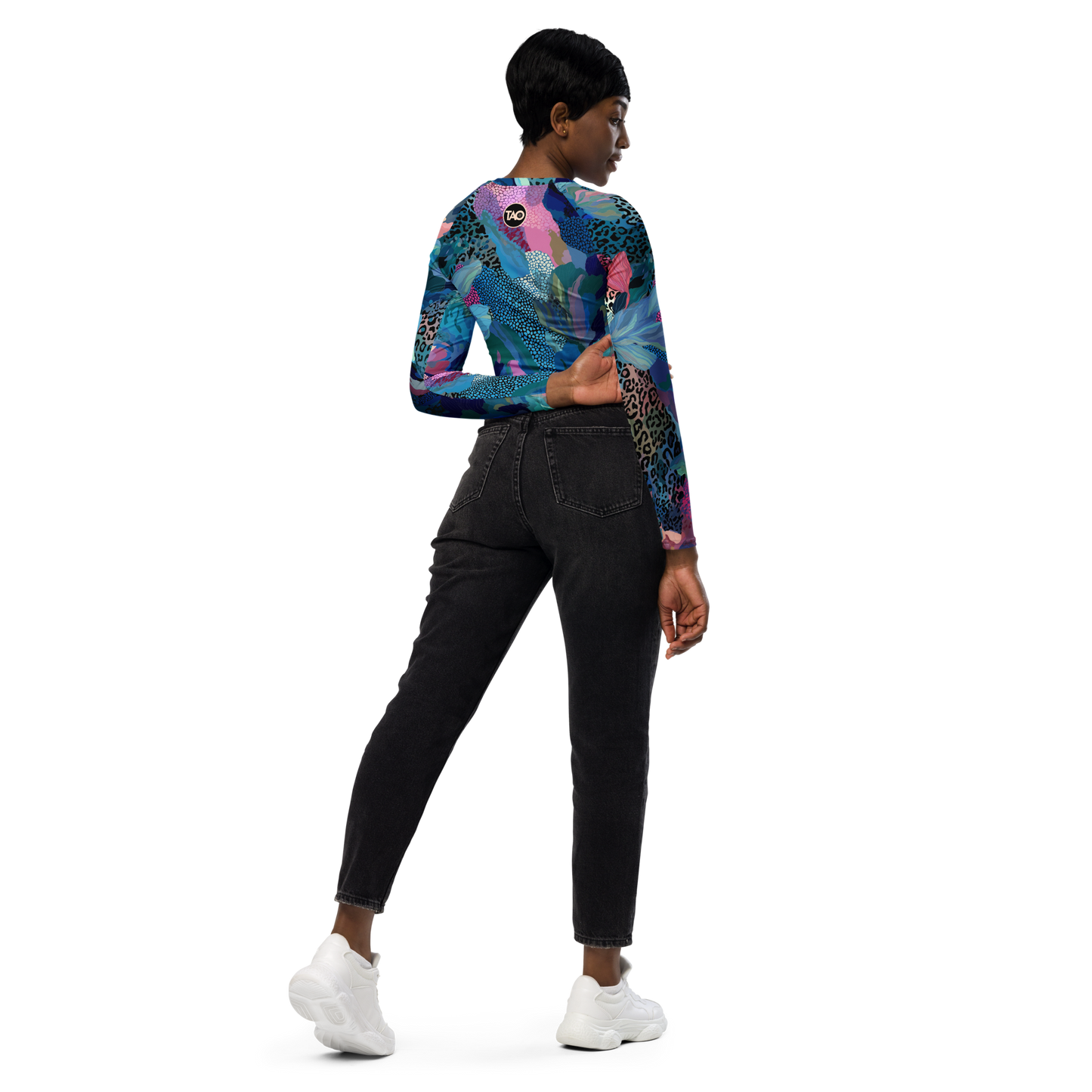 Woman wearing a blue camo-print long sleeve crop top with raglan sleeves, double-layered waistband, and UPF 50+ protection — made from recycled fabric for stylish, eco-conscious performance.