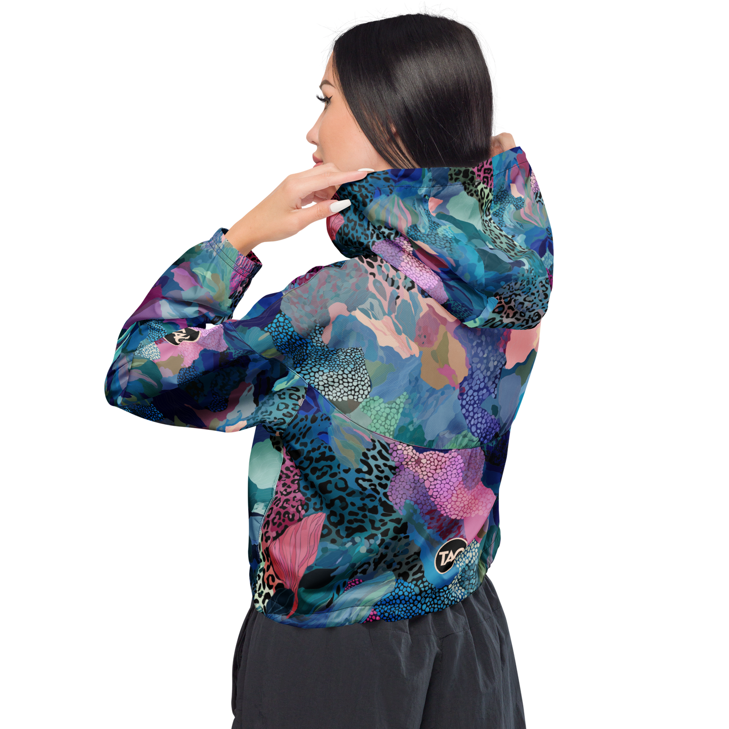 Cropped windbreaker featuring a bold blue camo print with adjustable hood and waist drawcords, breathable mesh lining, and side-slit pockets — designed for lightweight protection and standout style.