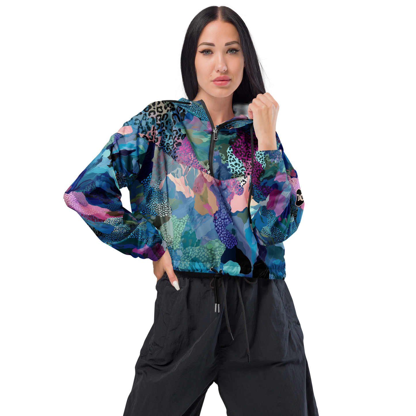 Cropped windbreaker featuring a bold blue camo print with adjustable hood and waist drawcords, breathable mesh lining, and side-slit pockets — designed for lightweight protection and standout style.