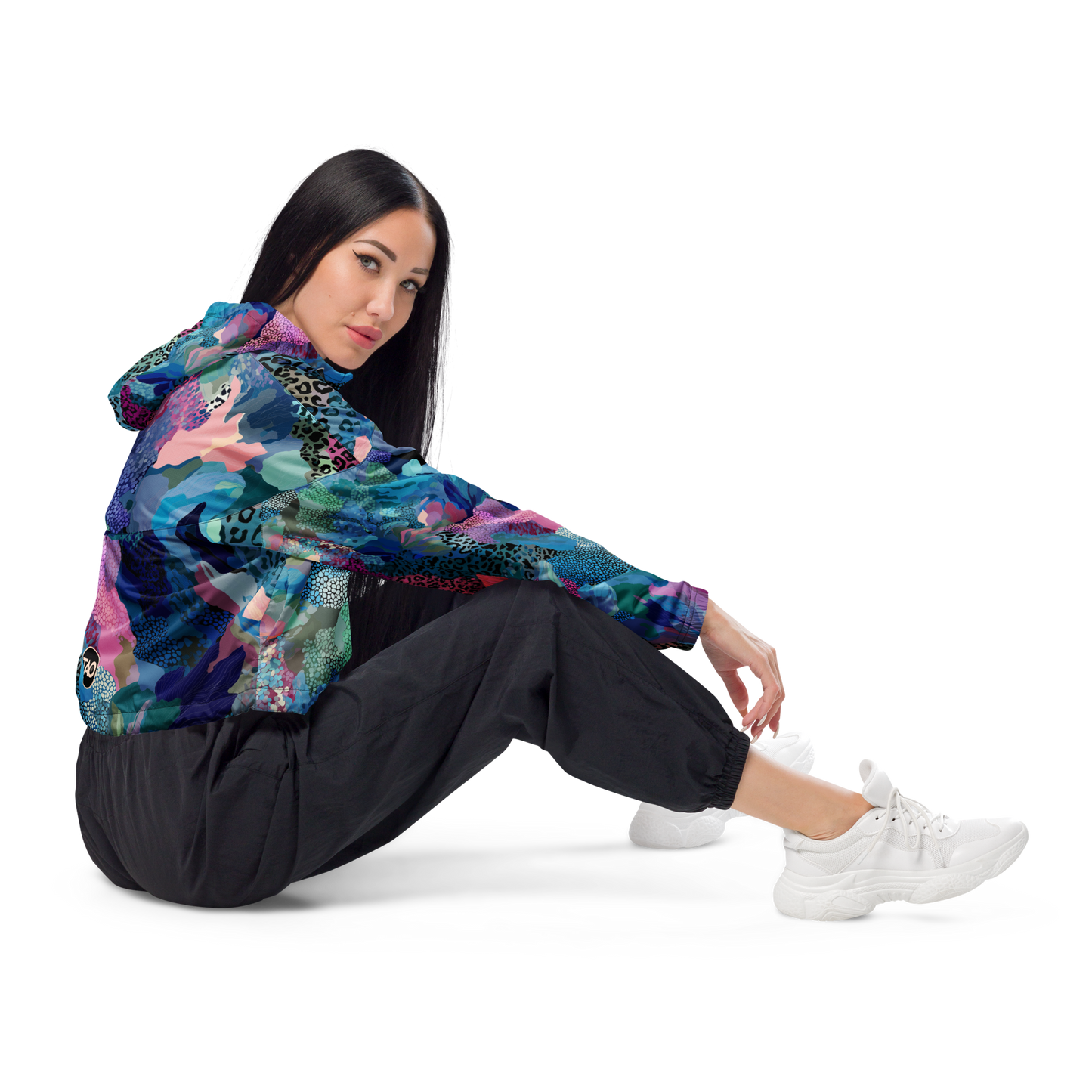 Cropped windbreaker featuring a bold blue camo print with adjustable hood and waist drawcords, breathable mesh lining, and side-slit pockets — designed for lightweight protection and standout style.