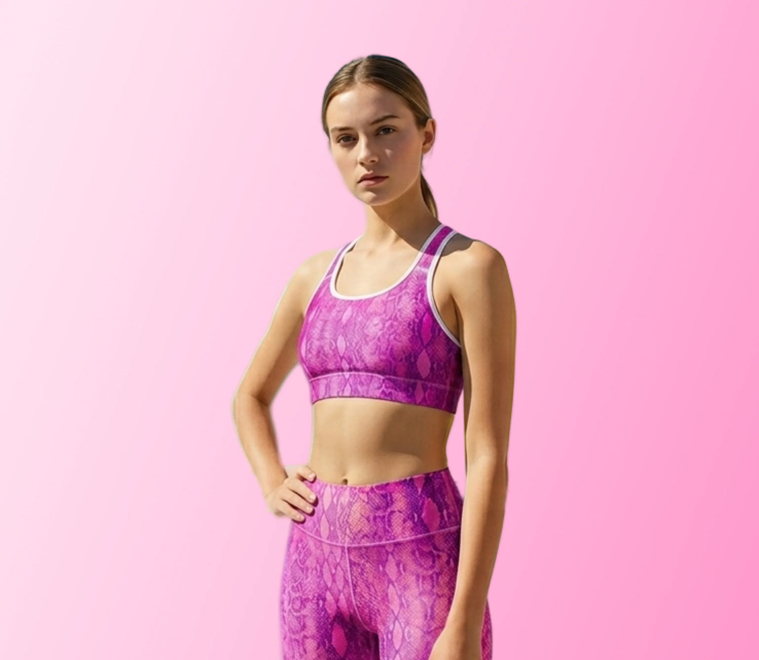 A woman wearing Fuchsia Snake Skin padded sports bra on Blue Sports Bra showing bold snake pinky print, with smooth double-layered fabric and racerback stitching