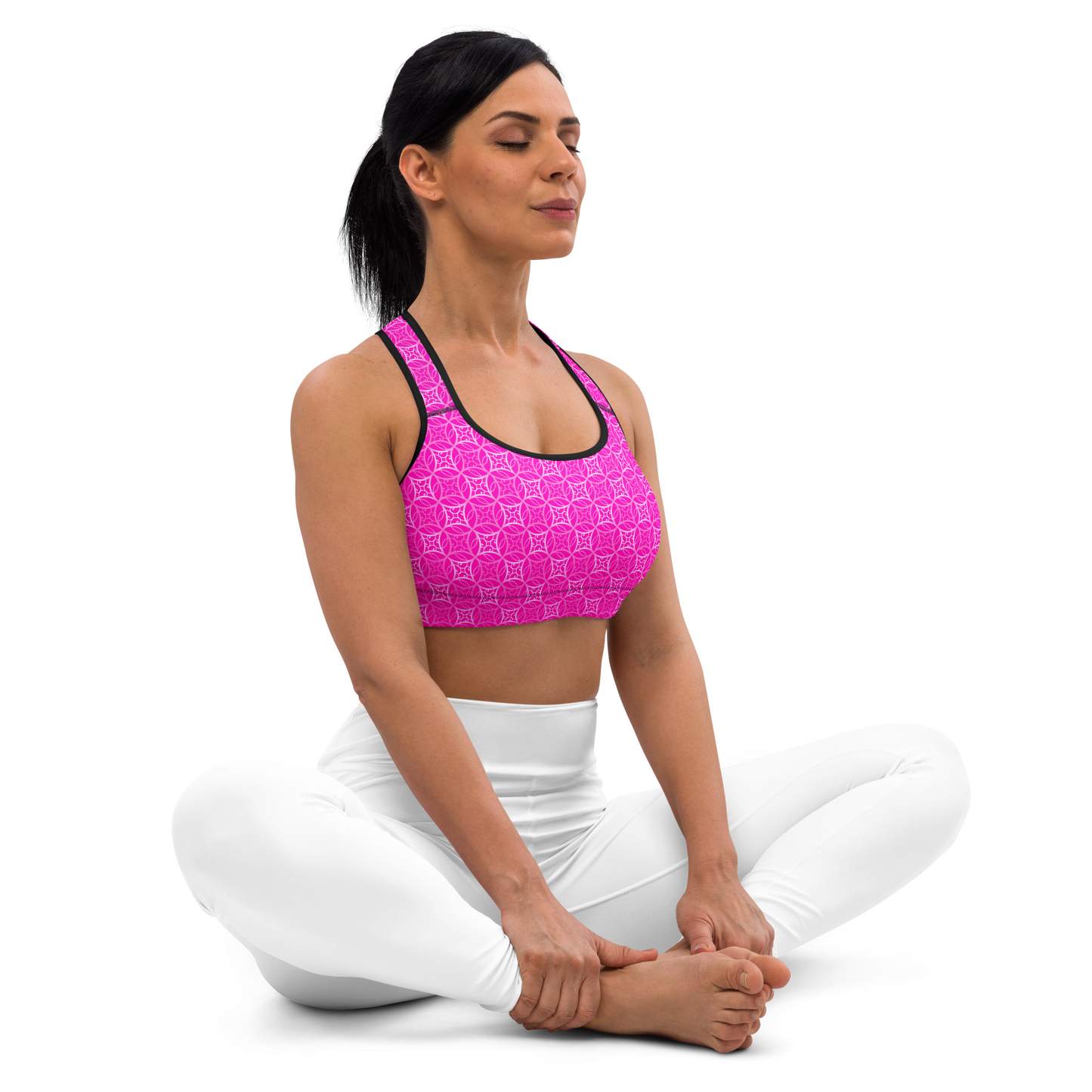 Model wearing Fibbo Pinky Sports Bra with pink sacred geometry design, featuring scoop neckline, racerback, and wide elastic band for support.