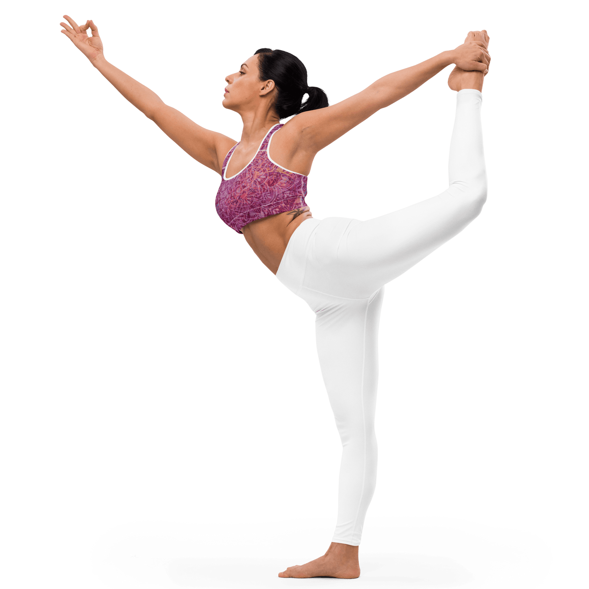 Woman in a vibrant Mandala Glow sports bra, mid-stretch in a serene outdoor yoga setting, showcasing comfort and style.