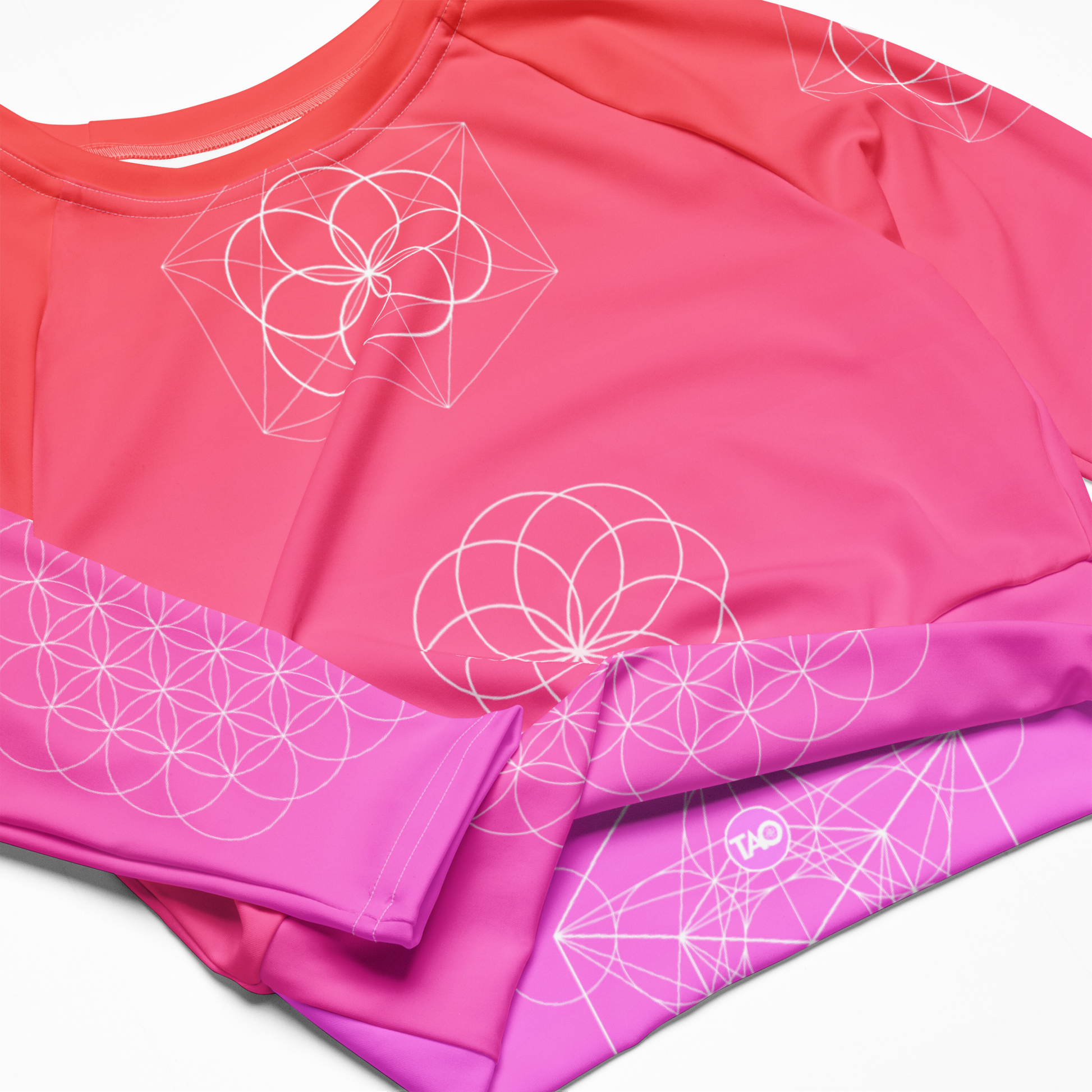 Model wearing Blush Flower of Life long-sleeve crop top with sacred geometry design and pink gradient – TAO Infinity