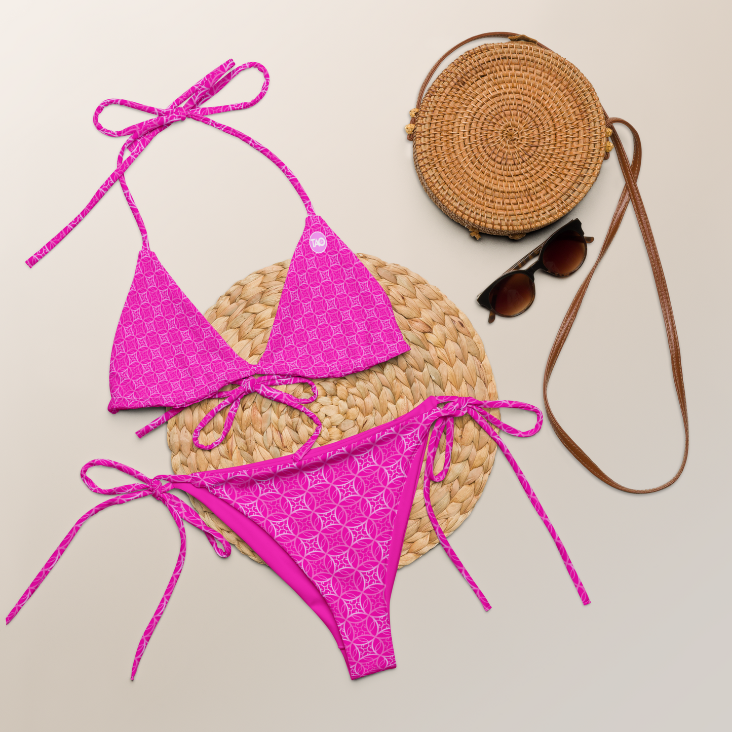 a pink string bikini with sacred Fibonacci-inspired all-over print, featuring adjustable straps, removable padding, and recycled fabric with UPF 50+ protection — a bold, sustainable, and symbolic swimwear look.