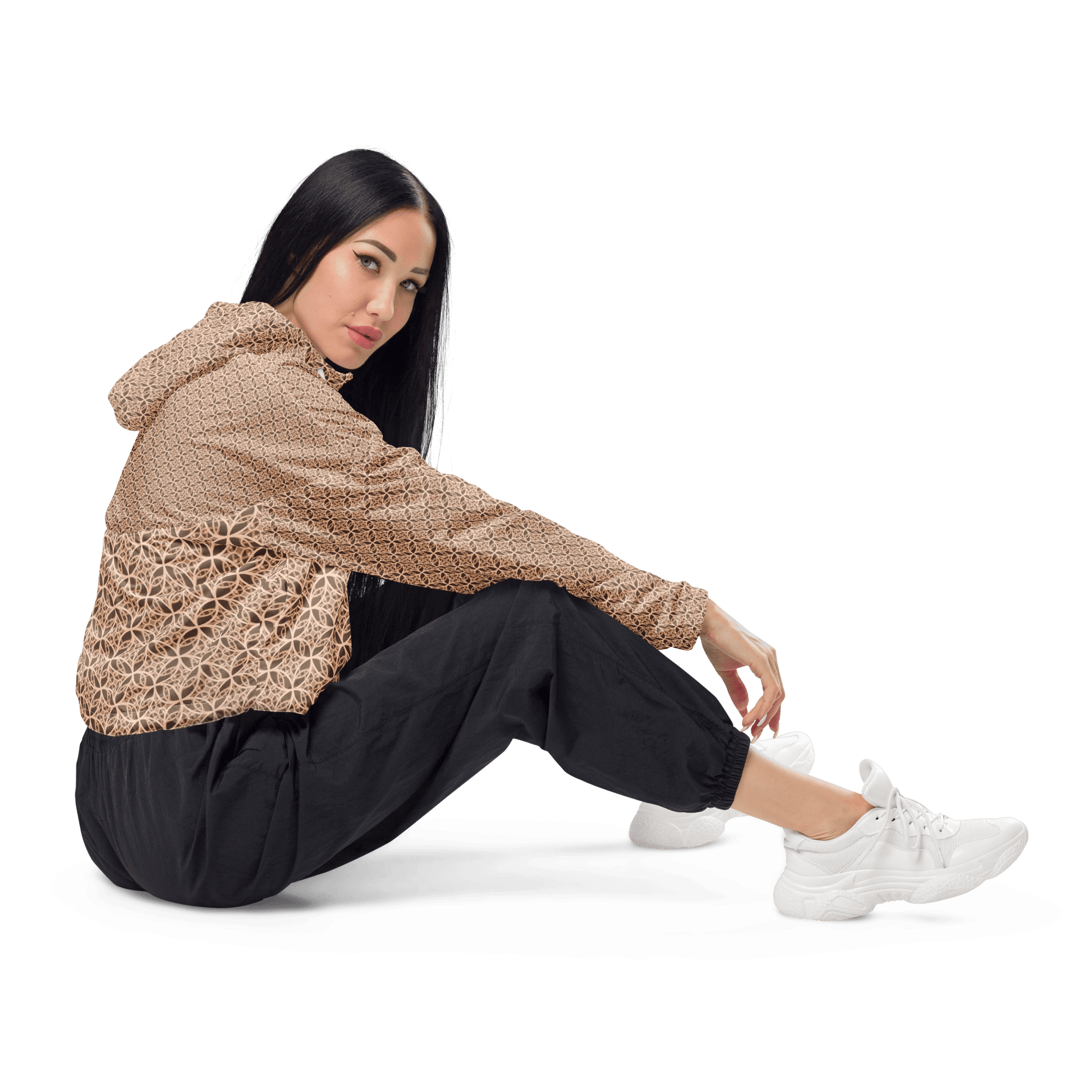 Woman wearing a lightweight beige cropped windbreaker with monogram Fibonacci pattern, featuring adjustable drawcords, side-slit pockets, and mesh lining — a waterproof, sacred-geometry inspired layer for mindful movement and conscious living.