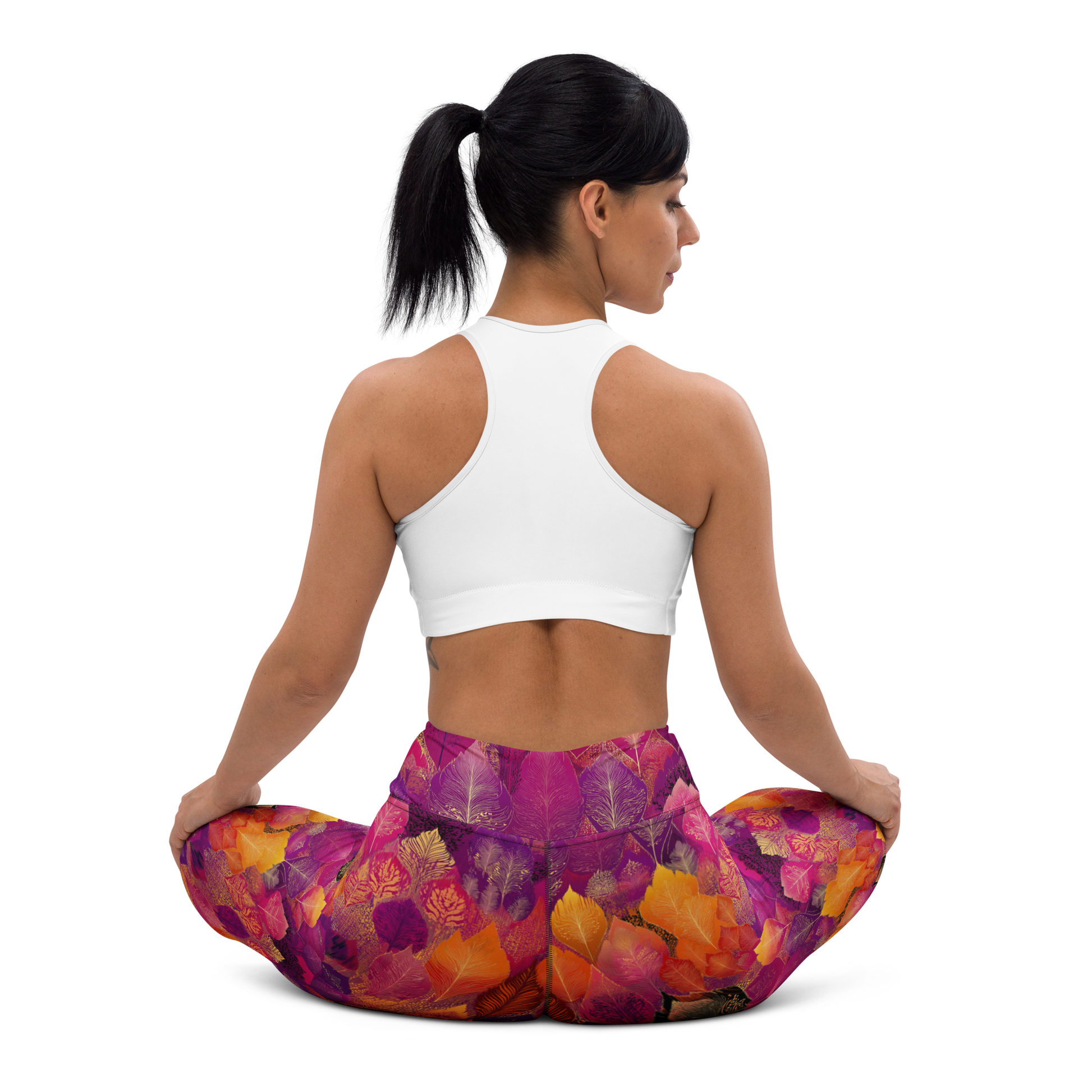 Woman wearing high-waisted yoga leggings in a bold, spice-toned Southeast Asian-inspired print, made from soft microfiber fabric with four-way stretch and a body-hugging fit.